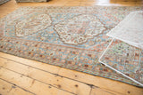 Distressed Mahal carpet corner with faded denim, terracotta geometric vinery and floral designs.