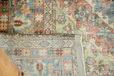 Distressed Mahal carpet's worn pile, faded denim blue, and secured hand-knotted selvedge.