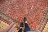Karabagh carpet's tomato red field, allover Herati motif, Mir Serbend border, and low pile wear.