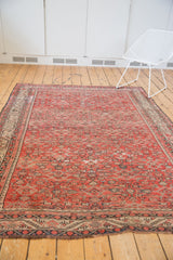Vintage Karabagh carpet with tomato red field, low pile Herati motif, and subtle abrash.