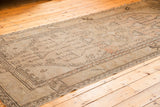 Distressed Oushak runner: geometric potted plants, faded blush, and even wear.