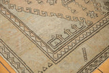 Distressed Oushak runner corner displaying geometric border in dark brown, light beige, and faded blush.