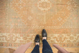 Vintage Distressed Oushak with worn dusty gold, pale blush, and dusty rose patterns.