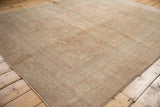 Soft, even low pile of a distressed vintage Oushak rug in faded apricot and sand.