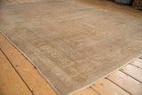Distressed vintage Oushak carpet, showing low pile texture and faded apricot, sand tones.