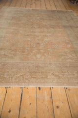 Secured end and low, distressed pile texture of the vintage Oushak carpet.