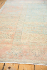 Decorative low pile of the distressed vintage Oushak rug in muted powder blue and terracotta tones.