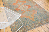 Distressed vintage Senneh rug with triple medallion and intricate Herati motif in terracotta and blue.