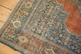 Distressed vintage Senneh rug edge, with blue Herati motif and worn terracotta.