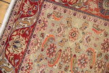 Ornate red border and pale seafoam green field with terracotta Herati motif on a vintage Kaisary rug.