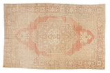 Vintage Distressed Oushak rug with oversized pale cinnabar red medallion, ivory field. 6'8