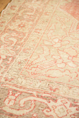 Distressed Oushak carpet texture, even wear with faint foundation through blush and ivory.