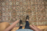 Traditional distressed Mahal rug with faded floral palmette and checkered pattern.