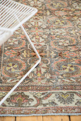 Distressed vintage Persian Mahal carpet with faded floral palmette motifs and worn pile.