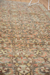 Distressed texture of vintage Mahal carpet, revealing floral palmettes, foundation wear, and terracotta tones.