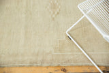 Vintage distressed Oushak rug's ivory low pile, subtle geometric pattern, and intact side selvage.