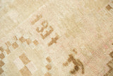 Vintage Oushak carpet's distressed pile texture revealing the '1937' date in pale tones.