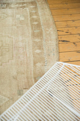 Distressed Oushak rug's textured side border, showing low pile and muted tones.