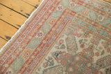 Distressed vintage Kayseri carpet corner: geometric borders in terra cotta, celadon, and ivory.