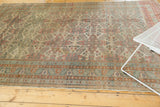 Distressed vintage Kayseri rug with geometric floral burst, highlighting worn pile and soft tones.