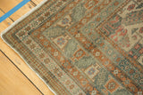 Distressed Kayseri carpet corner with geometric floral motifs in antique ivory, terra cotta, and celadon.