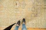 Distressed Vintage Oushak carpet with faded beige and muted geometric pattern, showing even wear and foundation.