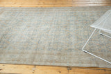 Distressed vintage Oushak rug pile with intricate faded floral pattern and faint foundation.