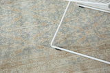 Distressed vintage Oushak rug texture with faint foundation, slate blue, ivory, and sand floral lattice.