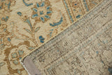 Distressed vintage Sparta carpet, showing ivory and blue floral pile and hand-knotted foundation.