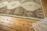 Distressed low pile with primitive stylized patterns in antique ivory and oxidized silver.