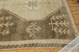 Vintage distressed Oushak carpet with primitive beige plant motifs on a charcoal ground.