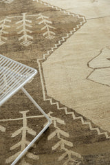 Distressed Oushak rug's low pile with primitive ivory plant motifs and charcoal tones.