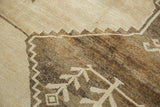 Distressed Oushak rug detail: low pile, visible knot heads, and primitive ivory motifs.
