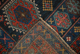 Geometric pile and intricate hand-knotted foundation of a folded vintage Kurdish rug.