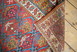Antique Northwest Persian rug with vibrant raspberry red pile and visible hand-knotted foundation.
