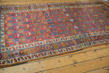 Antique Northwest Persian rug's raspberry red lattice and germinating plant motif with ornate borders.