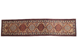 Antique Serab runner with repeating geometric medallions in cherry red and sapphire blue on a sand field.