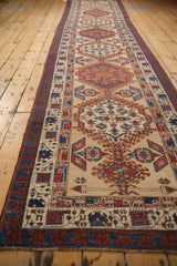 Angled perspective of an antique Serab runner highlighting the series of hooked medallions.