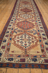Angled view down the length of an antique Serab runner, highlighting its repeating geometric medallions.