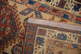 Hand-knotted construction and secured edge binding on the back of an antique Serab rug.
