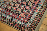 Intricate borders and multi-color boteh motifs on this antique Kurdish rug corner.