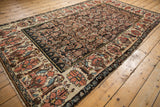 Vintage Bijar carpet's oversized antique ivory border with terra cotta and rose floral palmettes.