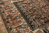 Vintage Kurdish Bijar rug: oversized navy blue main border with palmettes and floral motifs.