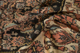 Vintage Kurdish Bijar rug folds reveal repeating herati pattern, terra cotta palmettes, and ivory floral motifs.