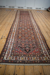 Vintage Malayer runner, intricate germinating flower motif, low pile, madder red, blue, and gold tones.
