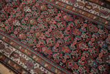 Vintage Malayer rug: brown field with red, blue, gold floral motifs and distinct cream border.