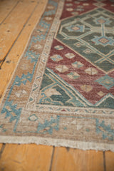 Distressed antique Malayer runner, showing geometric border in seafoam green, wine, and sand.