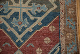 Antique Malayer runner detail: distressed geometric pattern in wine red, powder blue, pale sand, with foundation showing.