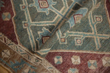 Malayer runner's folded pile shows wear, abrashes, and geometric patterns in sea foam green, bronze, plum.