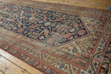Vintage Malayer runner, henna plant and lattice motif in navy, terracotta, and ivory, showing wear.